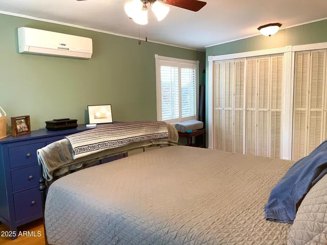 a bedroom with a bed and a window