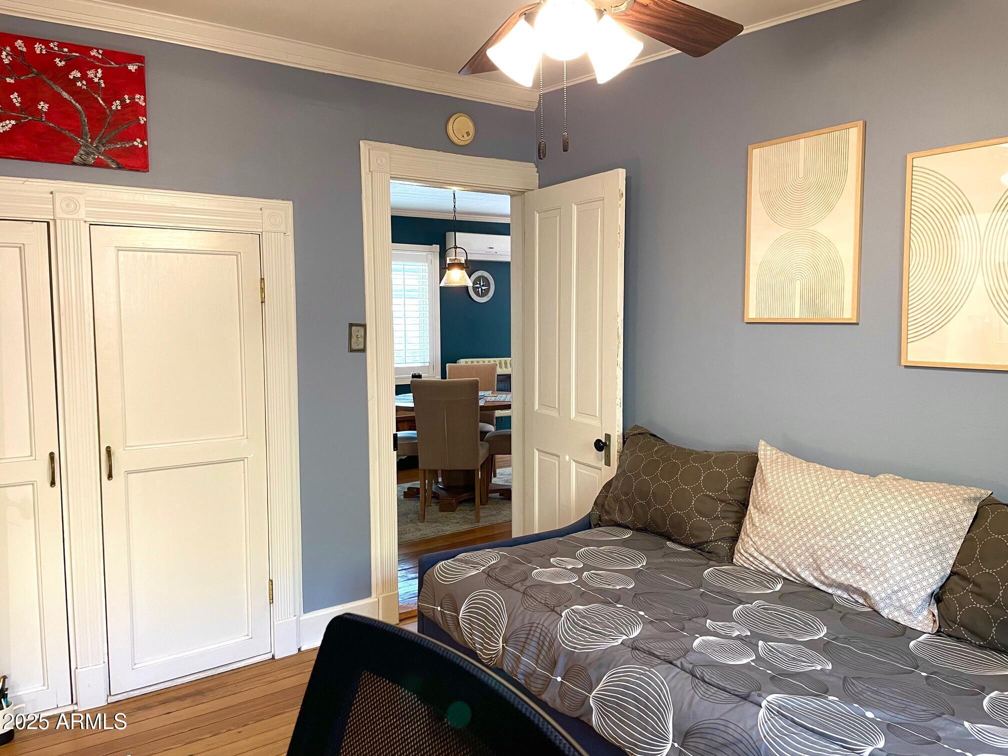 10 Locklin Avenue Bisbee, AZ 85603 - Photo 29 of 35 a bedroom with a bed and wooden floor