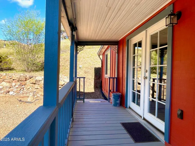a view of a balcony with wooden floor and outdoor space