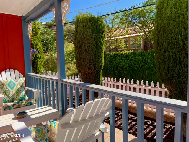 a view of a chairs and table in the balcony