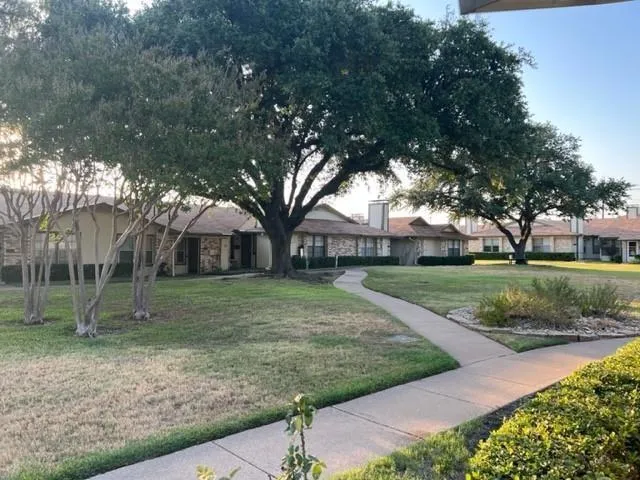 a view of a house with a backyard