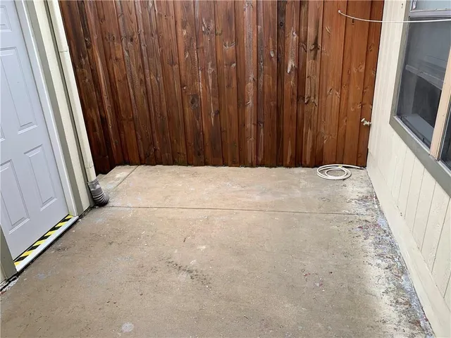 a view of an empty room with wooden walls