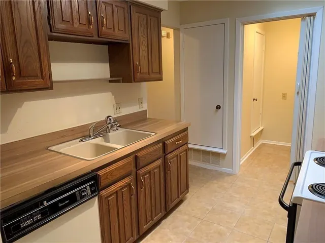 a kitchen with a sink appliances and cabinets