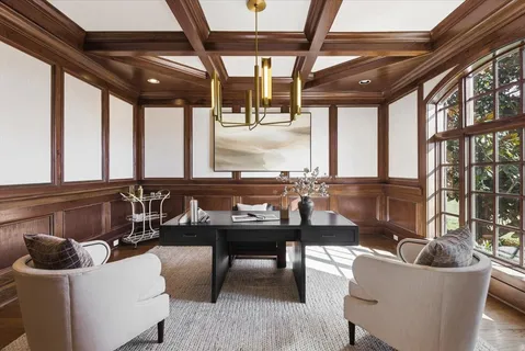 a kitchen with a sink stove cabinets and wooden floor