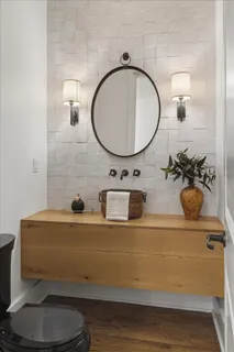 a living room with furniture a fireplace and a floor to ceiling window