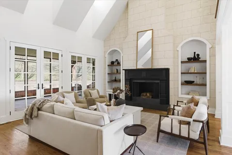 a living room with furniture a fireplace and a flat screen tv