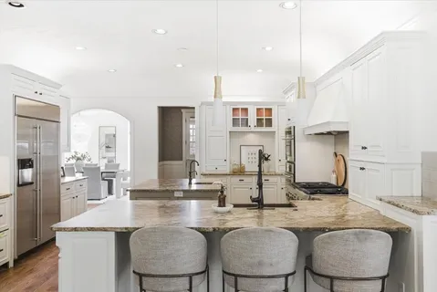 a view of a hallway with wooden floor and living room