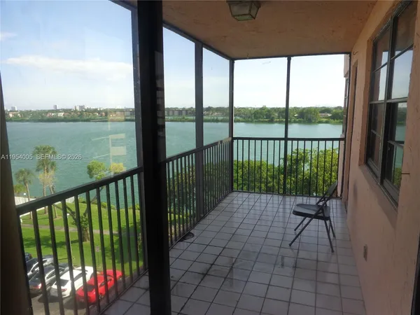 a view of balcony with floor to ceiling windows with wooden floor