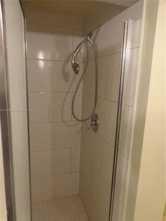 a bathroom with a glass shower door