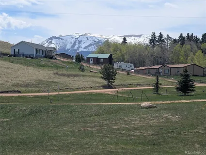 a view of a big yard with table and chairs