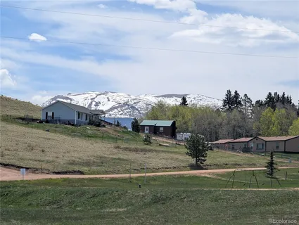 a view of a big yard with wooden fence