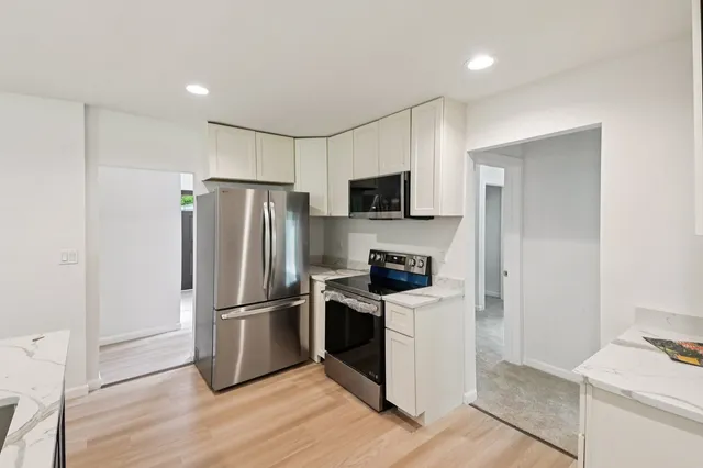 a kitchen with wooden cabinets and stainless steel appliances