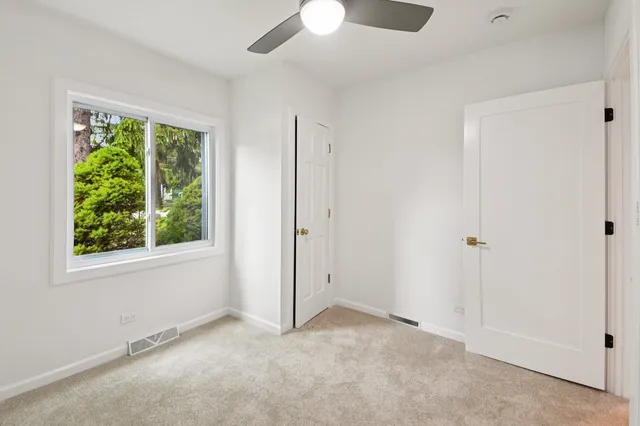 an empty room with windows and closet