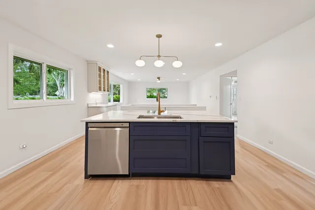 a kitchen with a sink cabinets and window