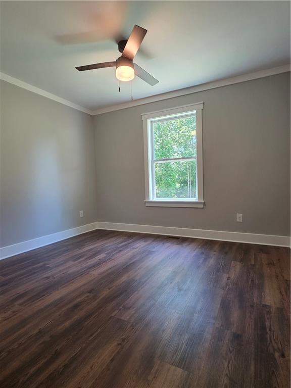 1217 Youngs Farm Road Cedartown, GA 30125 - Photo 16 of 29 an empty room with wooden floor and windows