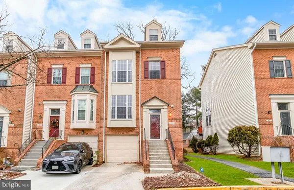a view of a car parked in front of a brick house