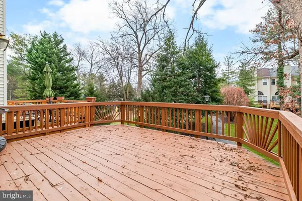 a balcony with wooden floor and fence