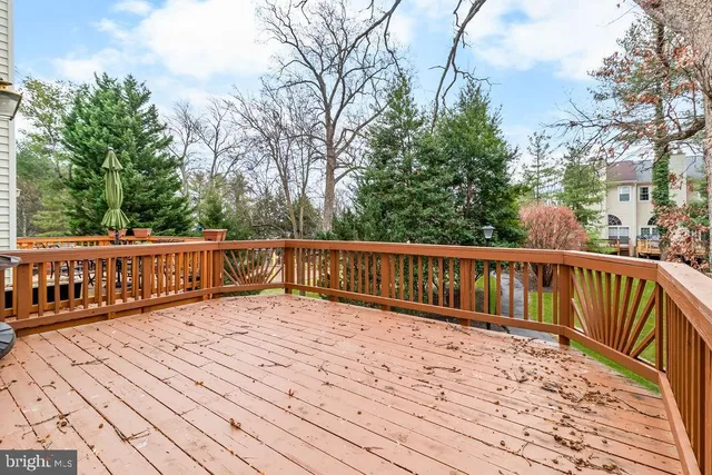 a balcony with wooden floor and fence
