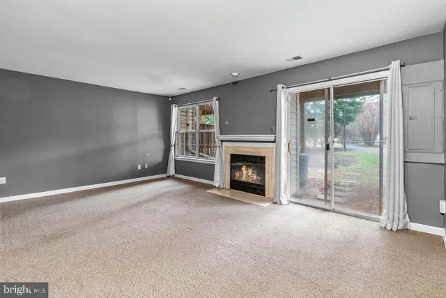 a view of empty room with a fireplace