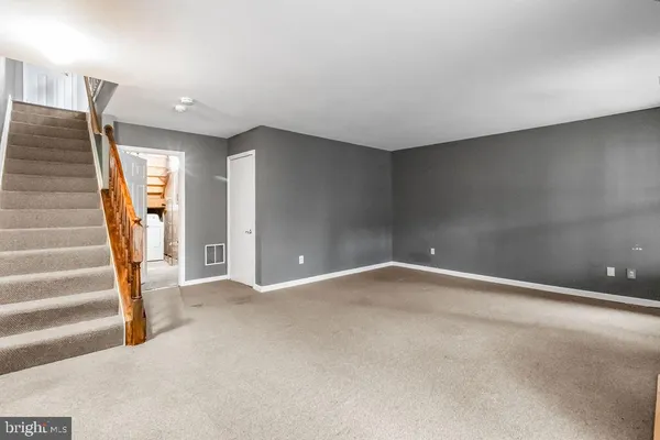 a view of an empty room with stairs