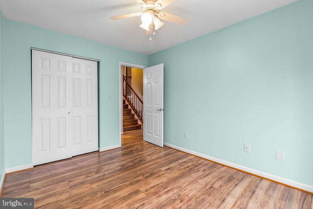 58 Silver Moon Drive Silver Spring, MD 20904 - Photo 24 of 34 an empty room with wooden floor chandelier fan and windows