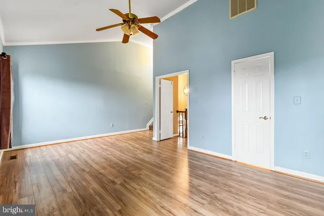 a view of an empty room and wooden floor