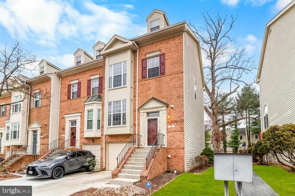 a couple of cars parked in front of a house