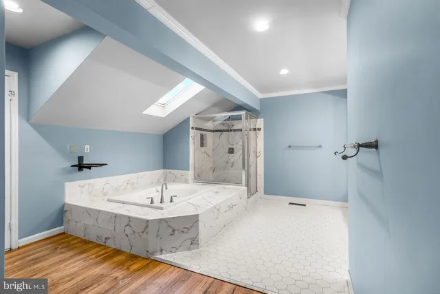 a spacious bathroom with a tub sink and mirror