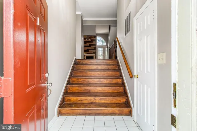 a view of staircase with white walls and windows