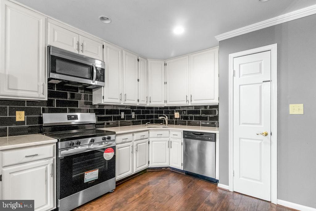 58 Silver Moon Drive Silver Spring, MD 20904 - Photo 8 of 34 a kitchen with stainless steel appliances granite countertop a stove and a microwave
