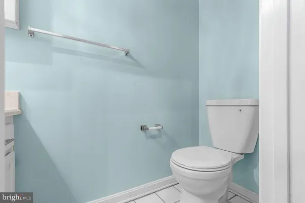 a white toilet sitting next to a shower