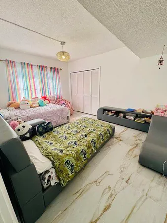 a bedroom with bed and a window