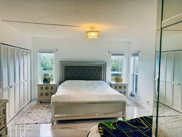 a bedroom with a bed and window