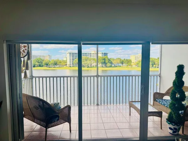 a view of a balcony with chair and a potted plant