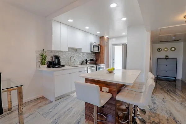 a kitchen with a table and chairs in it