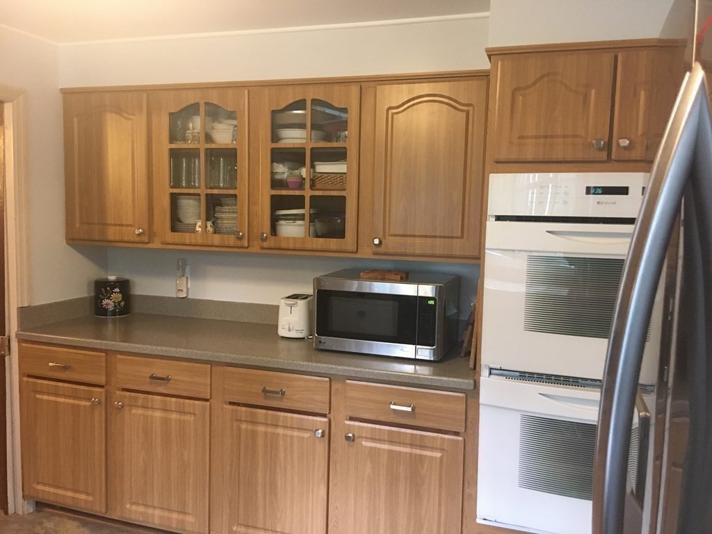 18 Butternut Drive Sutton, MA 01590 - Photo 12 of 34 a kitchen with stainless steel appliances granite countertop white cabinets and a refrigerator