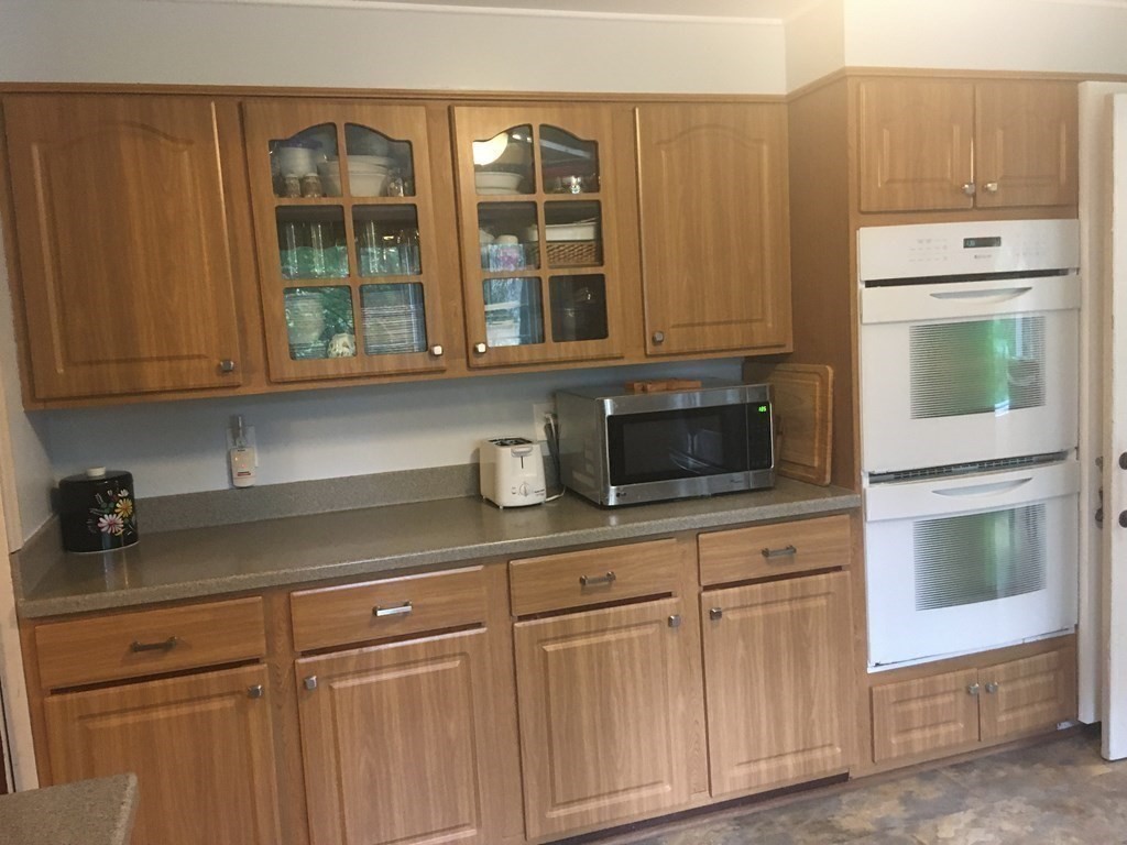 18 Butternut Drive Sutton, MA 01590 - Photo 13 of 34 a kitchen with stainless steel appliances granite countertop white cabinets and a granite counter tops