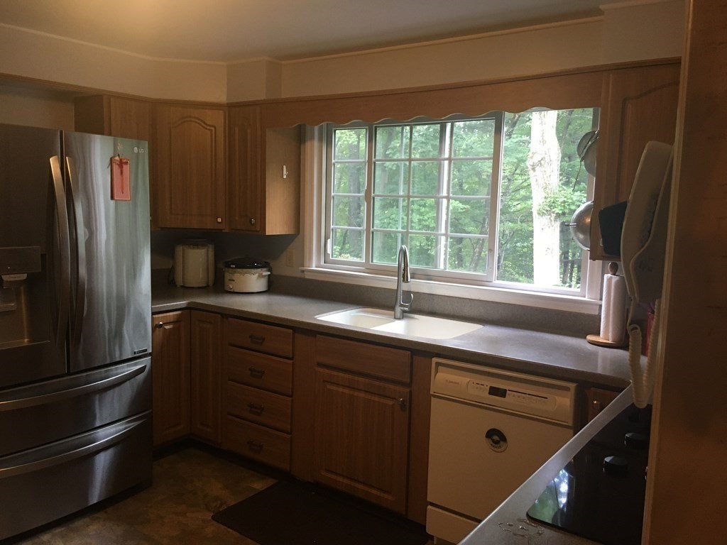 18 Butternut Drive Sutton, MA 01590 - Photo 14 of 34 a kitchen with stainless steel appliances granite countertop a refrigerator and a sink
