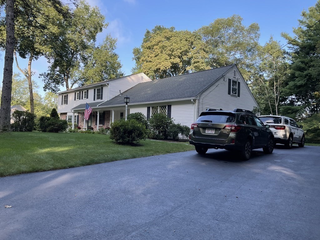 18 Butternut Drive Sutton, MA 01590 - Photo 2 of 34 a car parked in front of a house next to a yard
