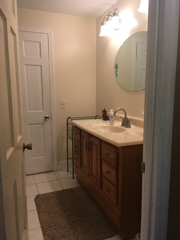 18 Butternut Drive Sutton, MA 01590 - Photo 23 of 34 a bathroom with a sink vanity and a mirror
