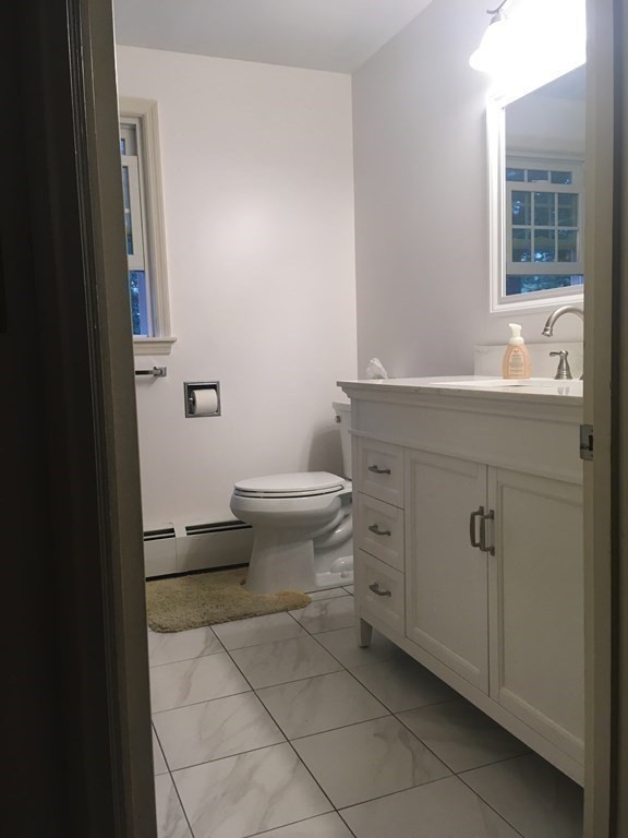 18 Butternut Drive Sutton, MA 01590 - Photo 25 of 34 a bathroom with a toilet sink and mirror