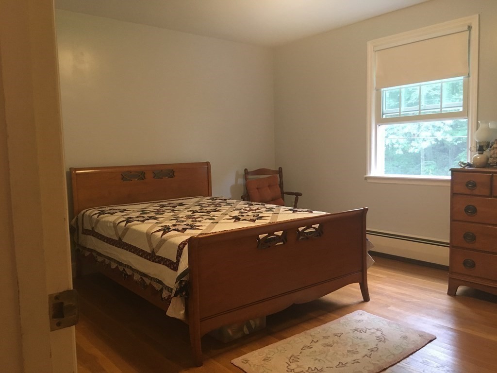 18 Butternut Drive Sutton, MA 01590 - Photo 26 of 34 a bed sitting in a bedroom next to a window