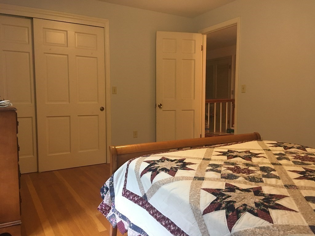 18 Butternut Drive Sutton, MA 01590 - Photo 27 of 34 a bed sitting in a bedroom next to a cabinet