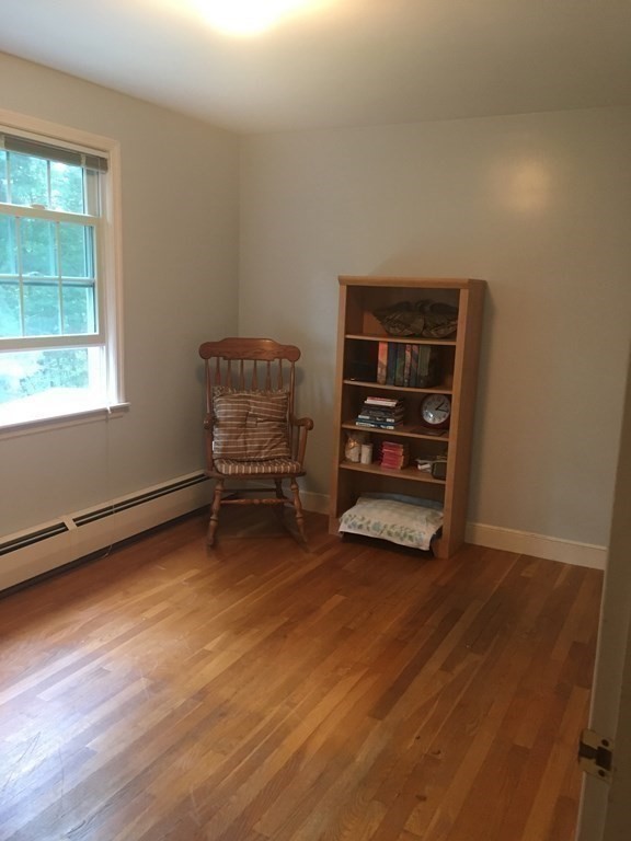 18 Butternut Drive Sutton, MA 01590 - Photo 29 of 34 a view of an empty room with a window and wooden floor