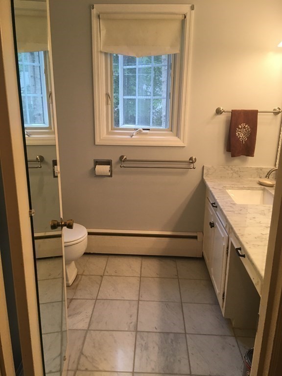 18 Butternut Drive Sutton, MA 01590 - Photo 30 of 34 a bathroom with a sink a toilet and a window