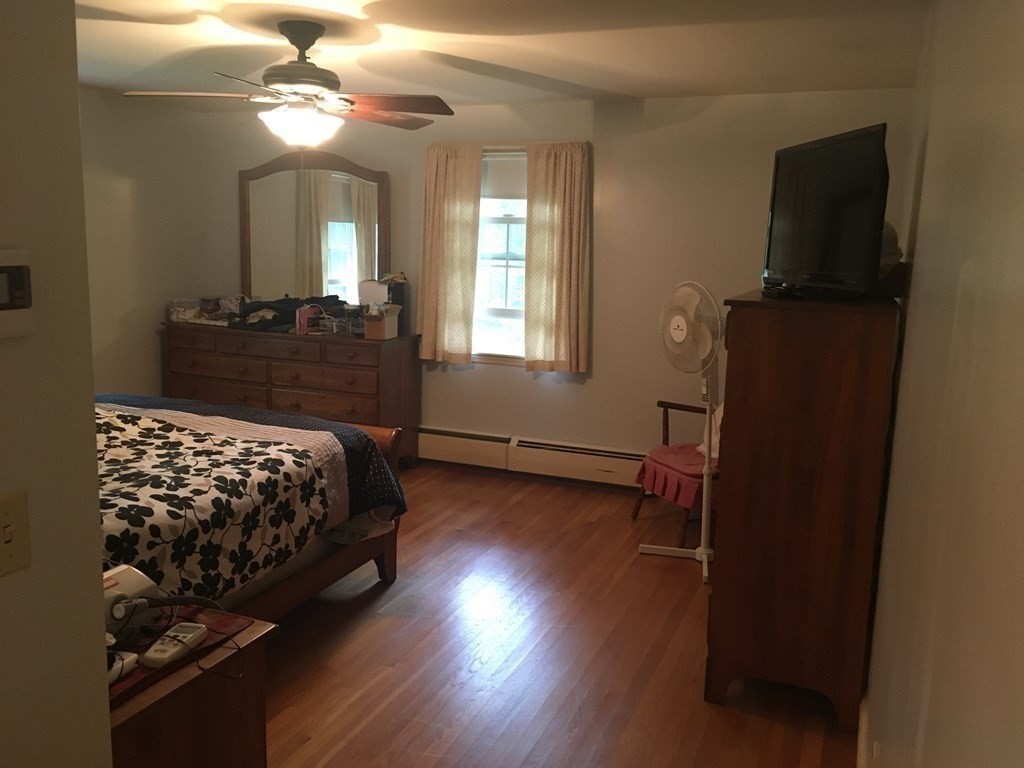 18 Butternut Drive Sutton, MA 01590 - Photo 34 of 34 a bedroom with a bed window and wooden floor
