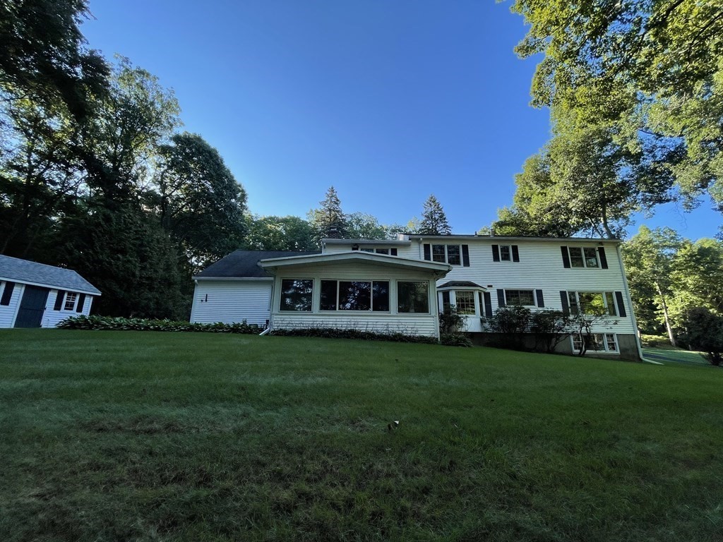 18 Butternut Drive Sutton, MA 01590 - Photo 4 of 34 a front view of a house with a garden