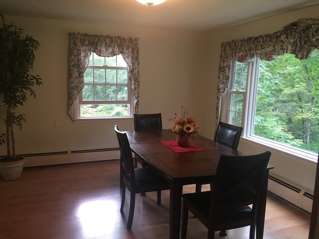 18 Butternut Drive Sutton, MA 01590 - Photo 9 of 34 a view of a dining room with furniture window and wooden floor