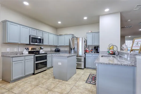 a kitchen with sink cabinets and stainless steel appliances