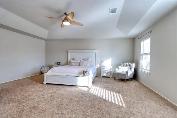 a bedroom with bed and window